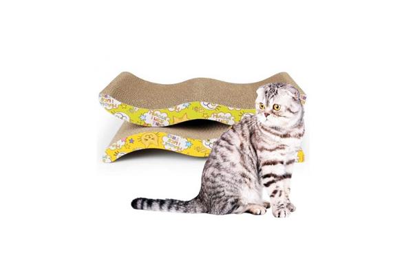 Gray cat sitting beside a wave-shaped cardboard cat scratching board for claw sharpening and play